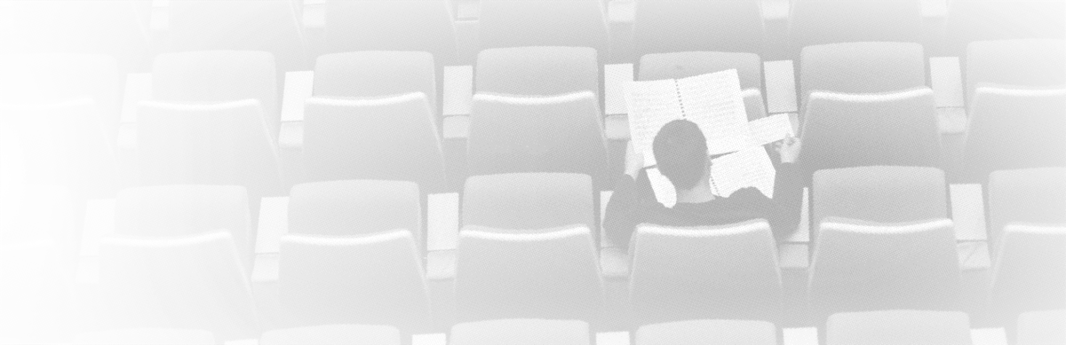A lone student in a lecture hall.